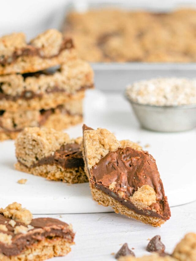 close up of revel bars on a white serving board. one is leaning off the board showing the diamond shape.