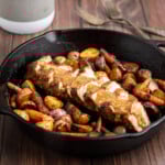 sliced pork tenderloin in a cast iron with gravy