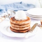 a stack of four pancakes with a scoop of vanilla ice cream on top