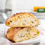 a cheddar jalapeno bread cut in half and stacked on top of each other.