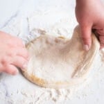 starting to stretch the pizza dough