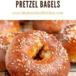 A close-up of golden brown, chewy pretzel bagels topped with coarse salt, cooling on a wire rack. Text above reads Chewy Homemade Pretzel Bagels and a website URL is displayed below.