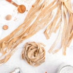 fresh homemade pumpkin pasta on a counter dusted with flour