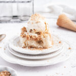 a scoop of crumb cake ice cream on top of a square of crumb cake
