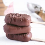 three chocolate covered ice cream pops stacked on top of each other