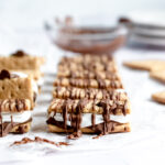 close up of a crispy meringue smore drizzled with chocolate