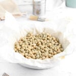 a pie crust lined with parchment paper and pie weights