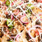 close up of loaded carnitas nachos