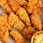 chex mix chicken tenders on a sheet pan.