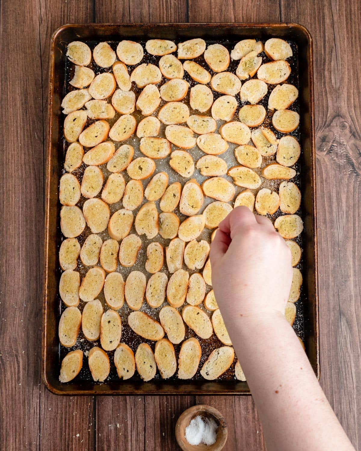 On the kitchen counter there is salt, pepper, cinnamon and olive