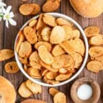 a bowl of bagel chips with a small bowl of salt nearby.