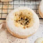 close up of a bialy with onion and poppy seed filling.