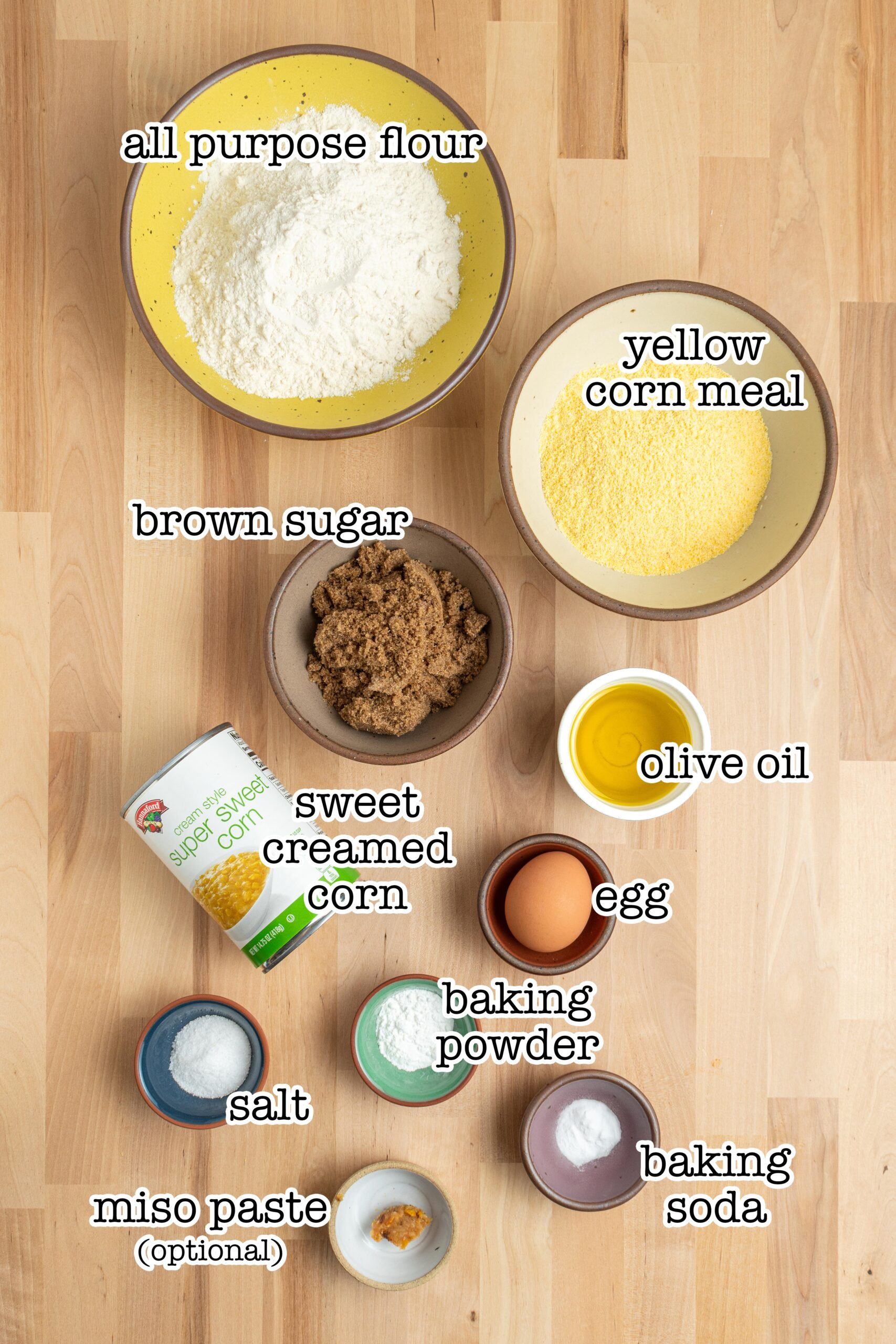 all the ingredients for cornbread muffins measured out and labeled.