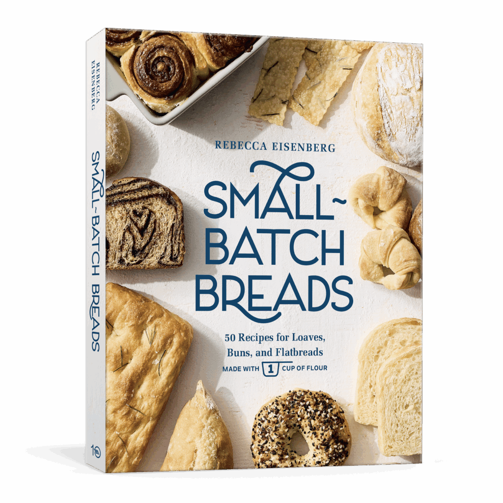 A cookbook titled Small-Batch Breads by Rebecca Eisenberg is shown. The cover features various types of breads and baked goods arranged around the book title and subtitle.