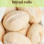 Several round, lightly golden bread rolls with slits on top are resting on a white cloth. Text above the rolls reads, homemade restaurant-style bread rolls. A website link appears at the bottom.